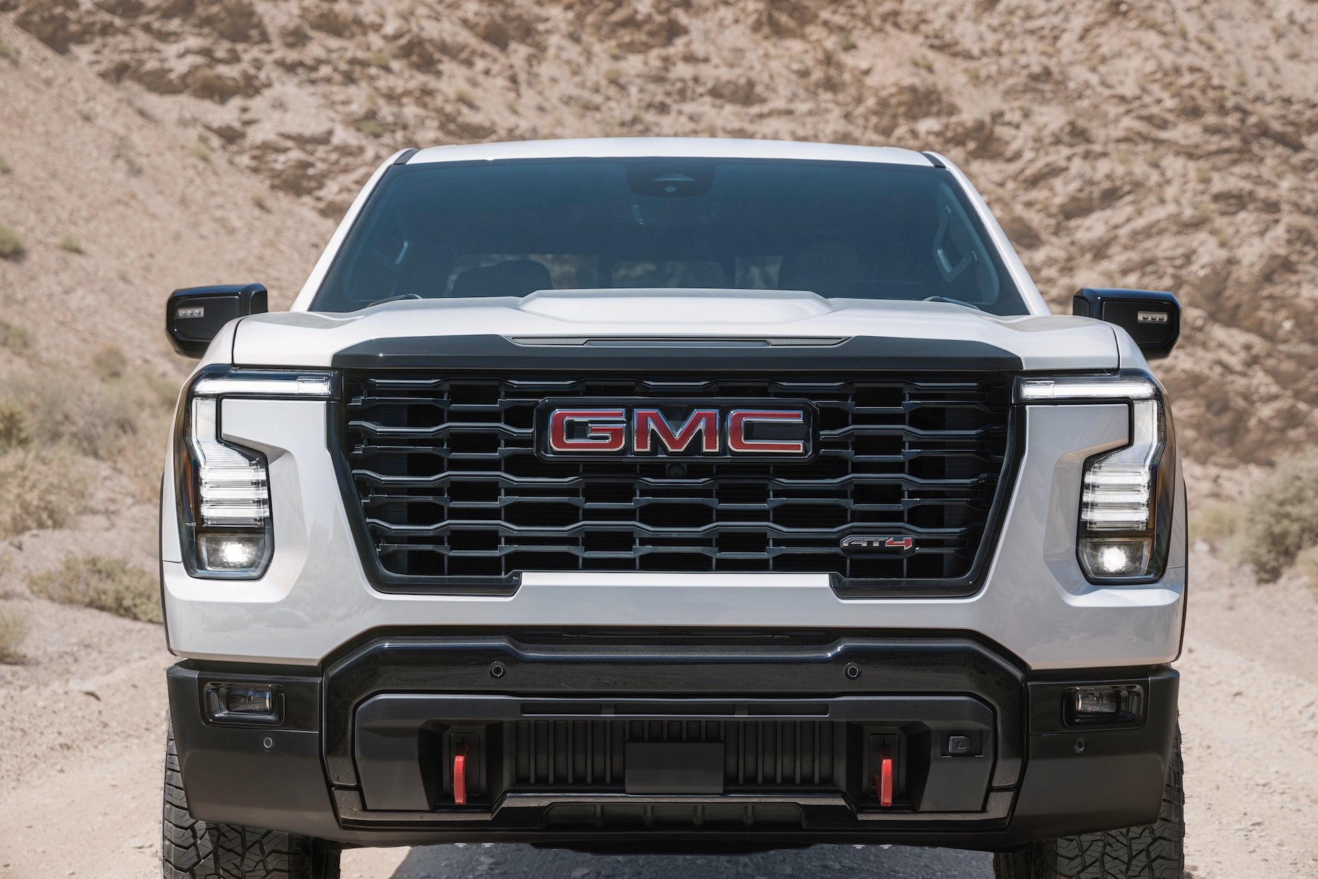 Front grille of a white 2027 GMC Sierra 1500 AT4